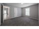 This bedroom features carpet flooring, a window, and a closet at 2374 Rolling Acres Sw Dr, Conyers, GA 30094
