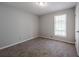 Clean bedroom featuring neutral paint, carpet and a window for natural light at 2374 Rolling Acres Sw Dr, Conyers, GA 30094