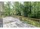Spacious wooden deck, perfect for outdoor relaxation and entertainment, with a view of the surrounding trees at 2374 Rolling Acres Sw Dr, Conyers, GA 30094
