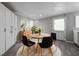 Bright dining area with modern furnishings, a round table, and ample storage in the white cabinets at 2374 Rolling Acres Sw Dr, Conyers, GA 30094
