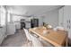 Eat-in kitchen featuring white cabinets, black appliances, and a wood table with white chairs at 2374 Rolling Acres Sw Dr, Conyers, GA 30094