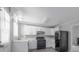 Bright kitchen features white cabinets, black appliances, and plenty of counter space at 2374 Rolling Acres Sw Dr, Conyers, GA 30094