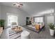 Bright living room with high ceilings, neutral decor, fireplace, and large windows offering natural light at 2374 Rolling Acres Sw Dr, Conyers, GA 30094