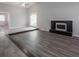 Living room with a unique tiered floor design and a black brick fireplace at 2374 Rolling Acres Sw Dr, Conyers, GA 30094