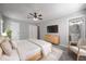 Cozy bedroom with soft carpet, neutral walls, a ceiling fan, and a doorway to an en-suite bathroom at 2374 Rolling Acres Sw Dr, Conyers, GA 30094