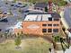 Aerial view of brick buildings at Summer City Center, surrounded by landscaping, parking lots, and roads at 3350 Hillshire Dr, Cumming, GA 30028