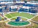 An aerial view showcases an outdoor amphitheater in the heart of a commercial district, complete with a pond at 3350 Hillshire Dr, Cumming, GA 30028