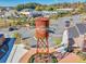 An aerial view showcases the Cumming City Center Water Tower, surrounded by parking lots and commercial buildings at 3350 Hillshire Dr, Cumming, GA 30028