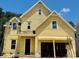 Charming yellow two-story home with a welcoming front door and attached two-car garage at 3350 Hillshire Dr, Cumming, GA 30028