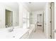 Bright bathroom features a double sink vanity, window shutters, and white tile flooring at 3759 Wescott Ne Cv, Brookhaven, GA 30319
