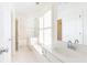 Bright bathroom features a double sink vanity, window shutters, and white tile flooring at 3759 Wescott Ne Cv, Brookhaven, GA 30319