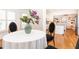 Cozy dining area featuring a round table, chairs, and a decorative vase with a glimpse into the open kitchen at 3759 Wescott Ne Cv, Brookhaven, GA 30319
