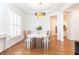 Bright dining room with tray ceilings, hardwood floors, and elegant light fixture at 3759 Wescott Ne Cv, Brookhaven, GA 30319
