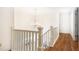 Upstairs hallway boasts hardwood floors and a chandelier at 3759 Wescott Ne Cv, Brookhaven, GA 30319