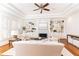 Bright living room with a fireplace, built-in shelving, shuttered windows, and hardwood floors at 3759 Wescott Ne Cv, Brookhaven, GA 30319