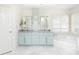 This well-lit main bathroom features double sinks, marble floors and lots of storage at 3759 Wescott Ne Cv, Brookhaven, GA 30319