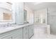 A bright main bathroom features double sinks, lots of natural light and marble floors at 3759 Wescott Ne Cv, Brookhaven, GA 30319