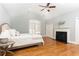 This main bedroom features vaulted ceilings, a ceiling fan and a fireplace at 3759 Wescott Ne Cv, Brookhaven, GA 30319