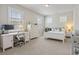 Bedroom with neutral walls, white trim, large windows, and a desk for studying at 518 Coral St, Marietta, GA 30064