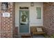 Inviting front porch with a cozy bench and decorative wreath, showcasing the charming entrance of the home at 518 Coral St, Marietta, GA 30064