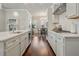 Spacious kitchen features white cabinets and countertops, stainless appliances, and wood floors at 518 Coral St, Marietta, GA 30064