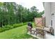 Relaxing backyard with patio seating, a grill, and lush green landscaping and privacy fence at 5638 Berney Cir, Powder Springs, GA 30127