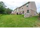 This backyard features a seating area, grill and lush green grass with a privacy fence at 5638 Berney Cir, Powder Springs, GA 30127