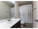 This bathroom features a modern vanity, toilet, and shower with a decorative shower curtain at 5638 Berney Cir, Powder Springs, GA 30127