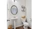 Cozy half bath featuring a pedestal sink and stylish decor for guests at 5638 Berney Cir, Powder Springs, GA 30127