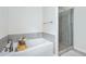 Clean bathroom featuring a soaking tub with a shower and a glass-enclosed shower stall at 5638 Berney Cir, Powder Springs, GA 30127