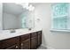 Well-lit bathroom featuring a double vanity with dark wood cabinets and ample counter space at 5638 Berney Cir, Powder Springs, GA 30127