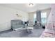 Nicely decorated bedroom featuring a crib, rocking chair, and ample natural light at 5638 Berney Cir, Powder Springs, GA 30127