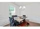 Bright dining room features a modern chandelier, stylish seating, and great natural light at 5638 Berney Cir, Powder Springs, GA 30127