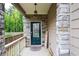 Stylish front door with stone accents and decorative lighting, adding character to the home's facade at 5638 Berney Cir, Powder Springs, GA 30127