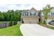 Well-maintained home with a two-car garage and a neatly landscaped front yard, offering inviting outdoor space at 5638 Berney Cir, Powder Springs, GA 30127