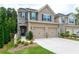 Charming two-story home featuring a stone facade and a two-car garage, enhancing curb appeal at 5638 Berney Cir, Powder Springs, GA 30127
