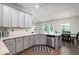 Modern kitchen with stainless appliances, gray cabinets, granite counters, and a dining nook at 5638 Berney Cir, Powder Springs, GA 30127