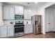 Spacious kitchen with stainless appliances, granite countertops, and gray cabinets at 5638 Berney Cir, Powder Springs, GA 30127