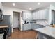 Open kitchen boasts stainless appliances, granite countertops, and sleek gray cabinetry at 5638 Berney Cir, Powder Springs, GA 30127