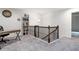 Cozy loft area featuring a desk, bookcase, and railing overlooking the stairs at 5638 Berney Cir, Powder Springs, GA 30127