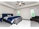 Spacious bedroom with a tray ceiling, large bed, sitting area, and plenty of natural light at 5638 Berney Cir, Powder Springs, GA 30127