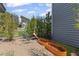 Landscaped backyard featuring a fire pit, lounge chairs, and planters for outdoor relaxation at 127 Ravenhurst Dr, Fayetteville, GA 30214