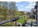 Exterior balcony with modern railing overlooking green space and neighborhood architecture at 127 Ravenhurst Dr, Fayetteville, GA 30214