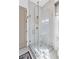 Modern bathroom with glass shower, tiled walls, and brass fixtures at 127 Ravenhurst Dr, Fayetteville, GA 30214
