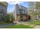 Modern home with a bright orange front door, balcony, landscaped yard, and stylish architectural details at 127 Ravenhurst Dr, Fayetteville, GA 30214