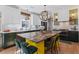 Kitchen boasts a spacious island with seating, custom cabinets, and modern pendant lighting at 127 Ravenhurst Dr, Fayetteville, GA 30214