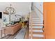 Open-concept living room with hardwood floors, stylish lighting, and modern staircase at 127 Ravenhurst Dr, Fayetteville, GA 30214