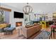 Cozy living room with a fireplace, modern furnishings, and a view into the kitchen at 127 Ravenhurst Dr, Fayetteville, GA 30214