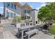Outdoor kitchen with grill, fireplace, dining table, and bench at 127 Ravenhurst Dr, Fayetteville, GA 30214