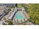 Aerial view of a stunning pool area with lounge chairs, landscaping, and shaded lounging at 127 Ravenhurst Dr, Fayetteville, GA 30214